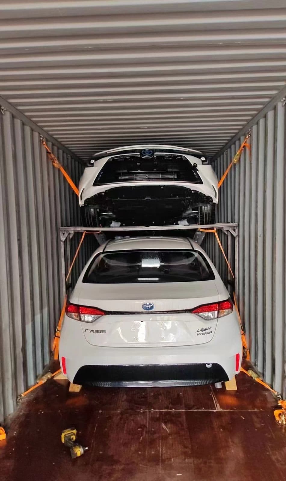 Vehicles strapped on a two-tier rack